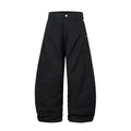 Men's black pleated wide-leg cotton trousers showing loose-fitting casual design