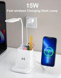 Black and white minimalist desk lamp with wireless charging pad, pen holder, and storage box.