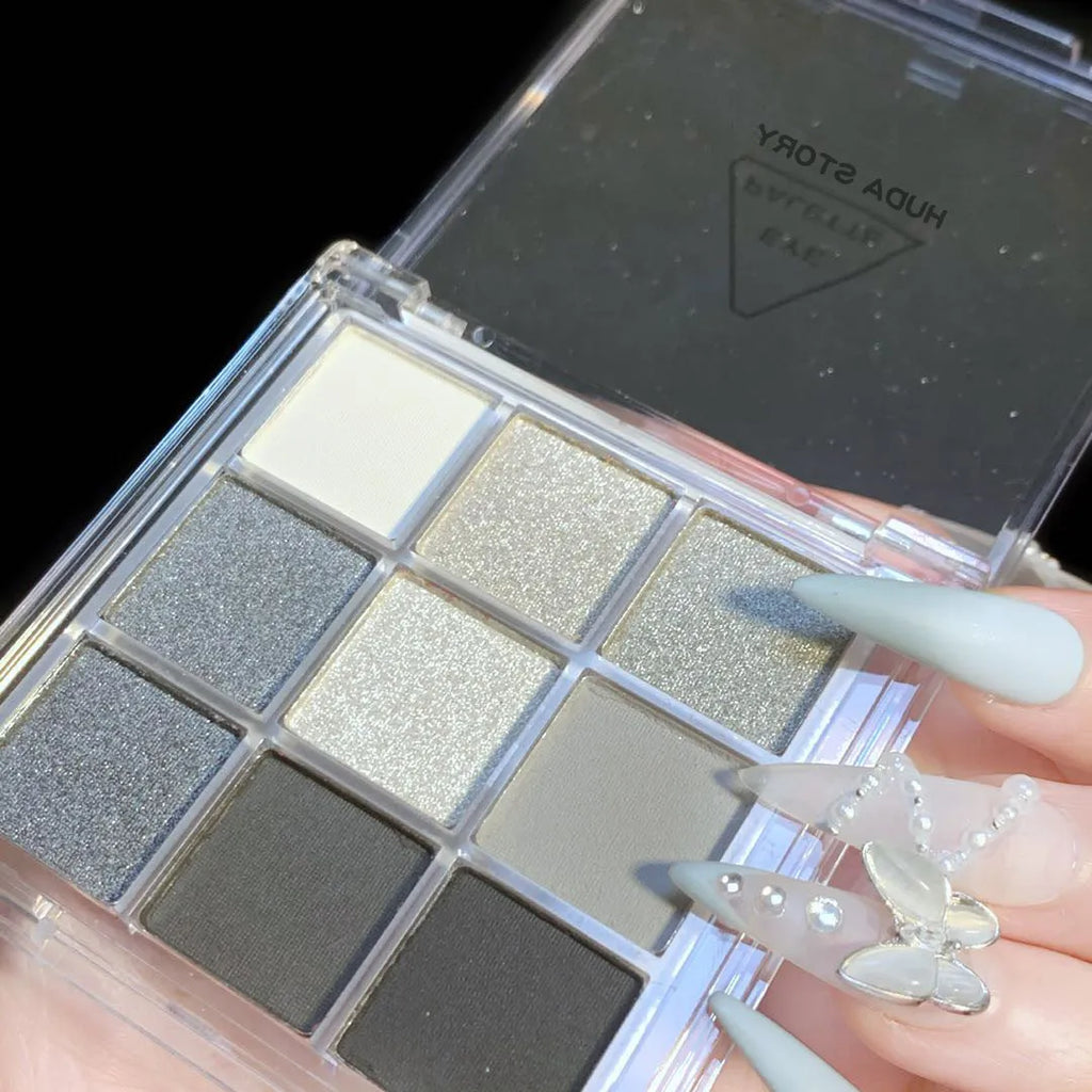Smoked nine-colour eyeshadow palette with white, silver, black, and iron grey shades.