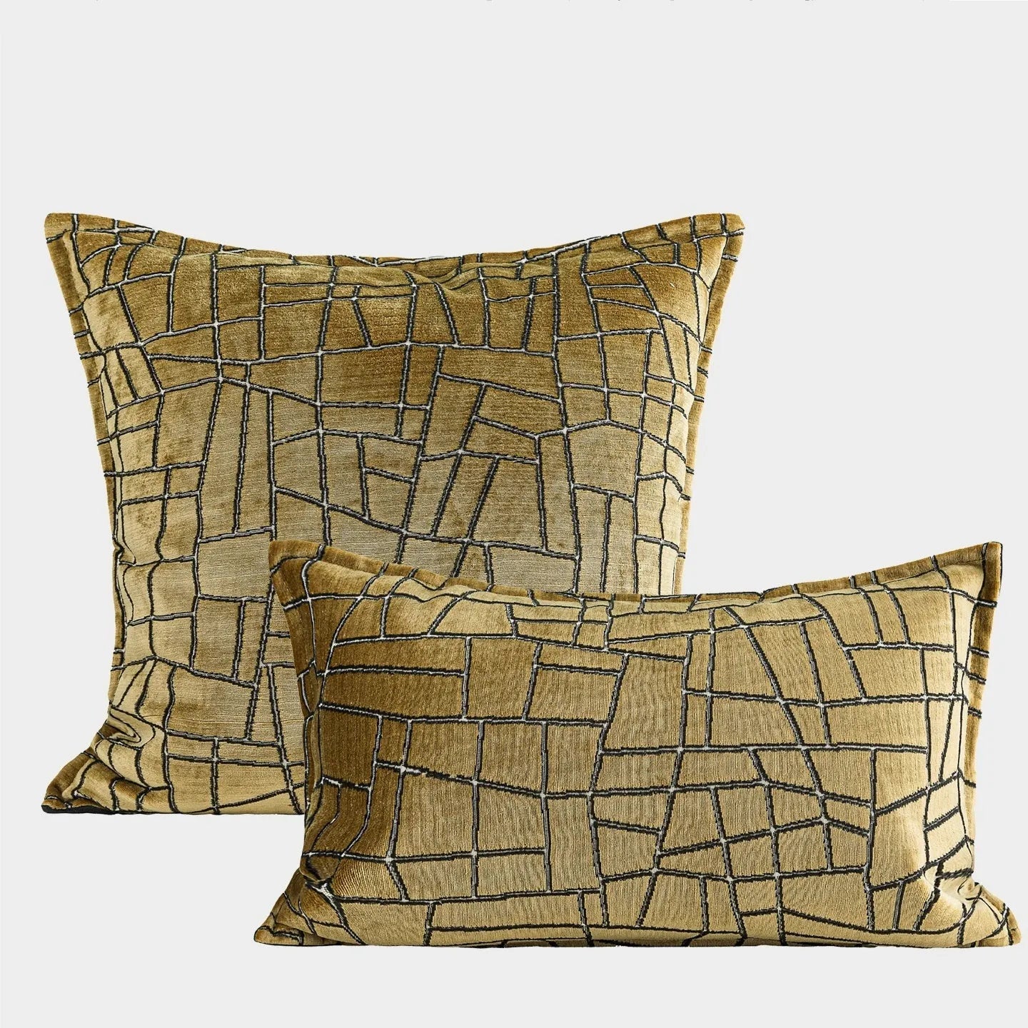 Geometric abstract patterned cushion cover in gold colour on a grey sofa, showing three size options.
