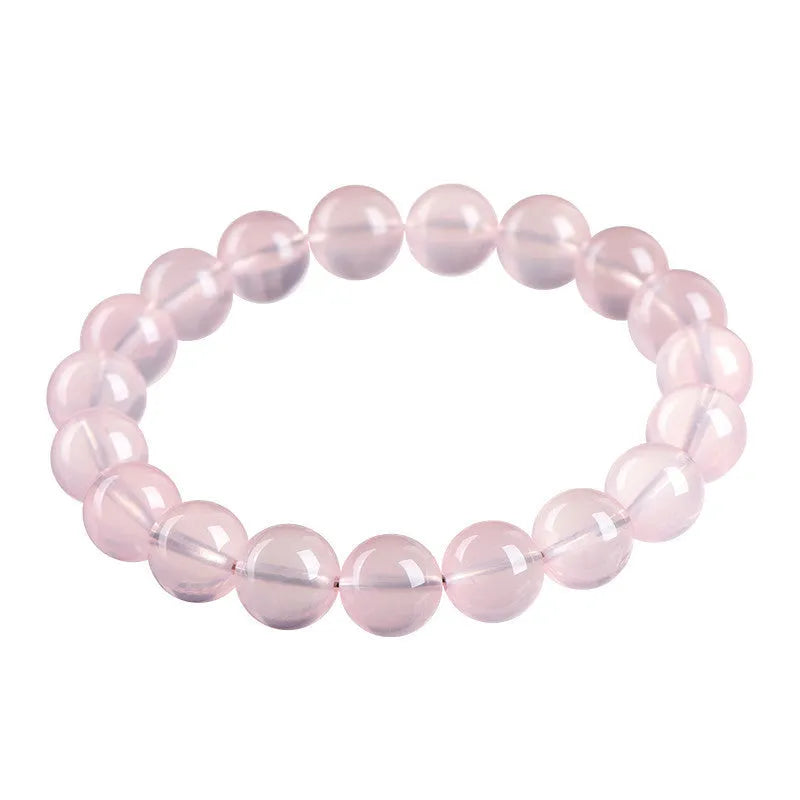 Natural pink starlight crystal round bead bracelet with polished 10mm stones on elastic cord