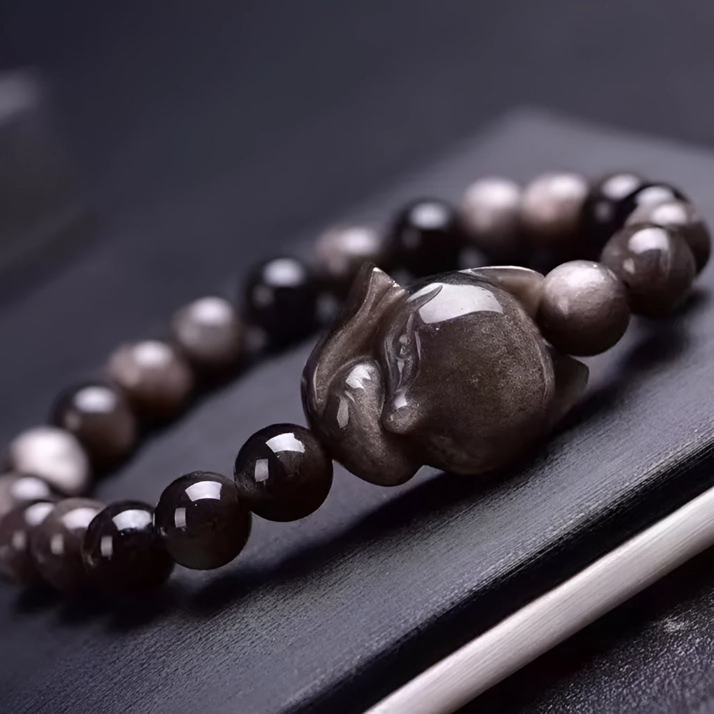 Obsidian fox bracelet with 8mm black stone beads and silver-toned fox charm on wrist