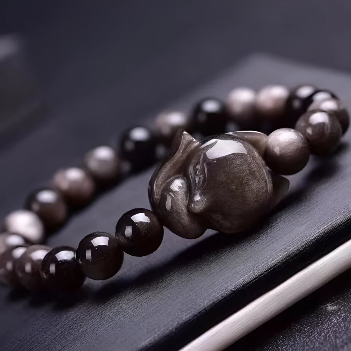 Obsidian fox bracelet with 8mm black stone beads and silver-toned fox charm on wrist