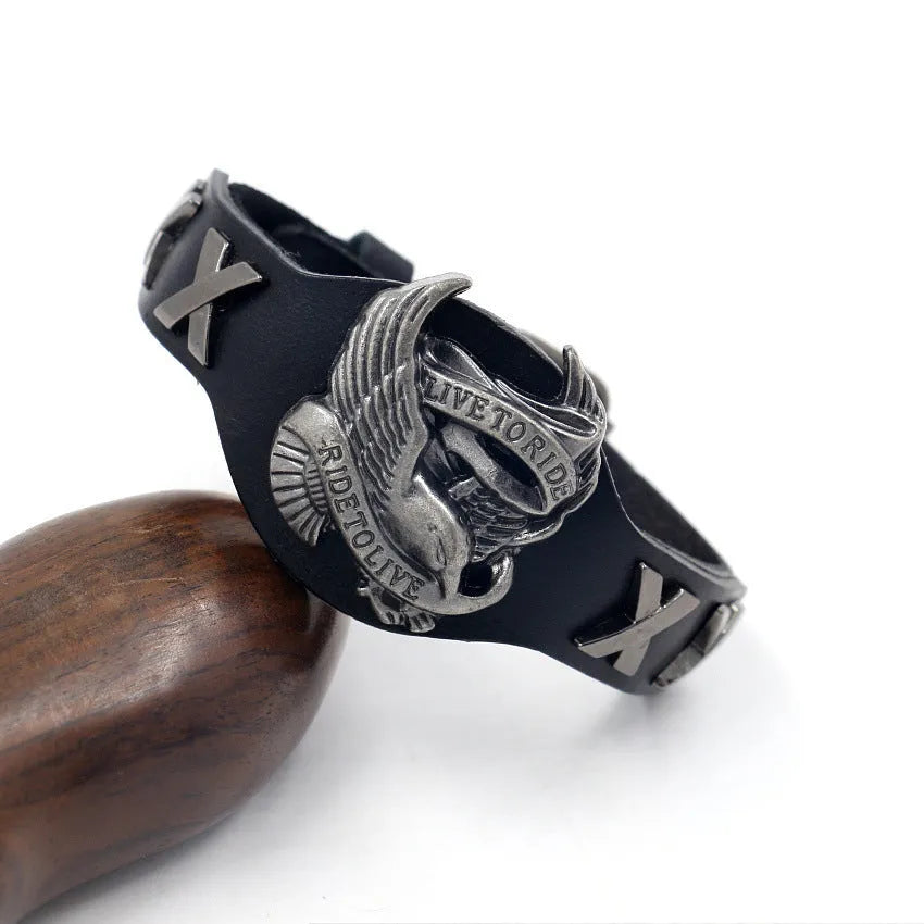 Black leather bracelet with a geometric alloy eagle watch-buttom decoration.