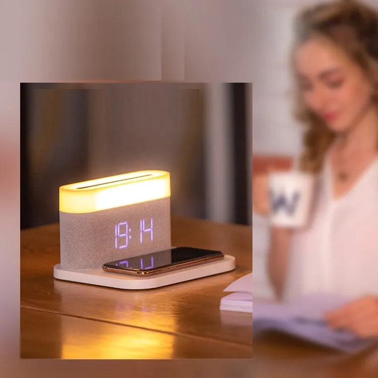 White wireless charging bedside lamp with digital alarm clock display on nightstand
