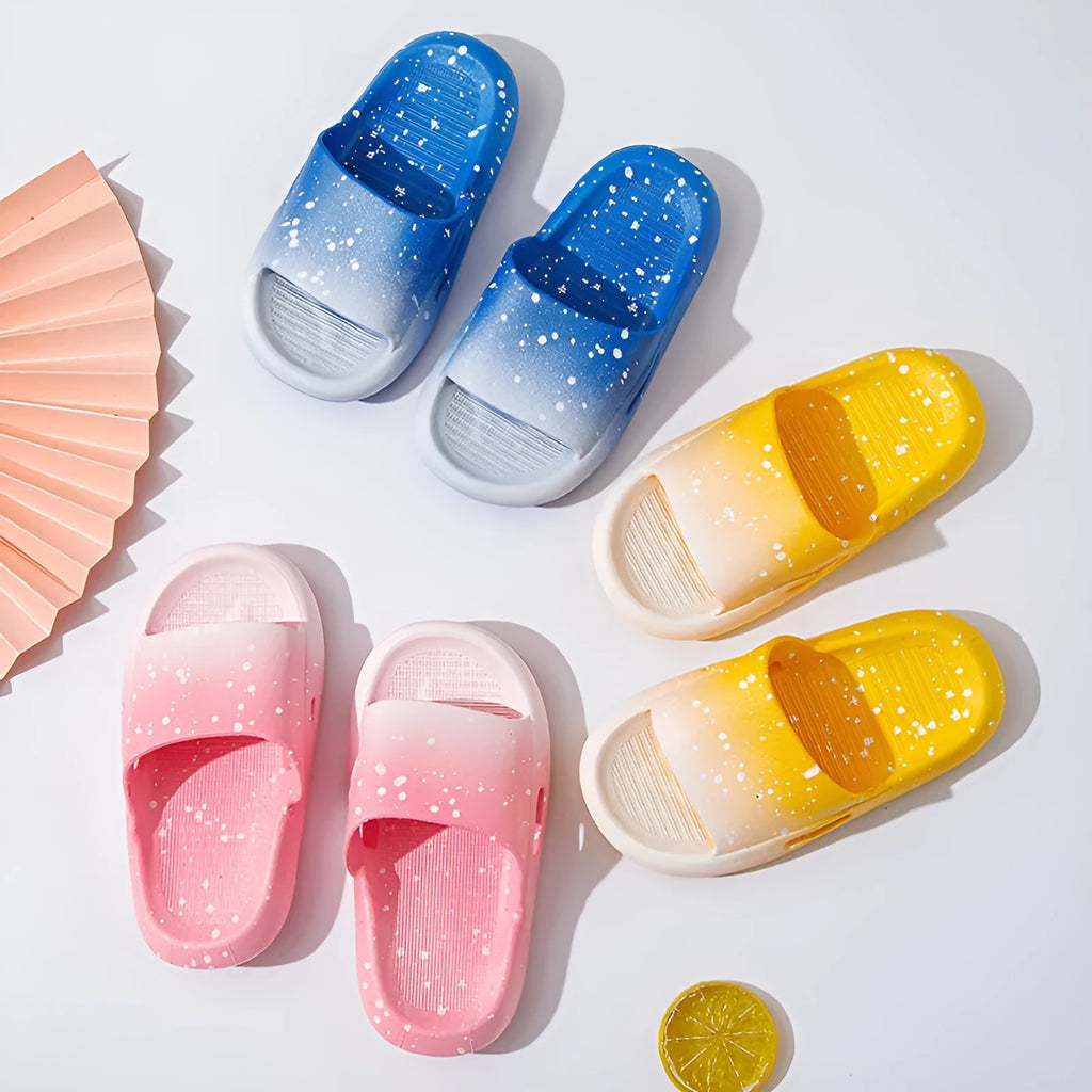 Blue gradient PVC slippers for children on a white background showing the non-slip sole pattern.
