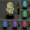 Black-based acrylic dream catcher night light with remote control on a table.