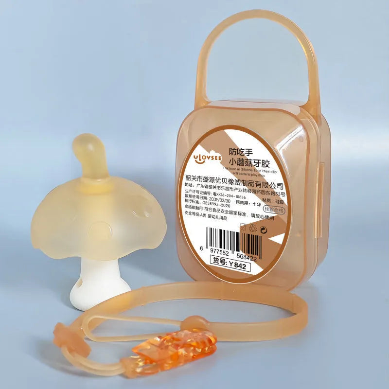 Small pink latex mushroom gum inside a transparent storage box with a thin silver chain.