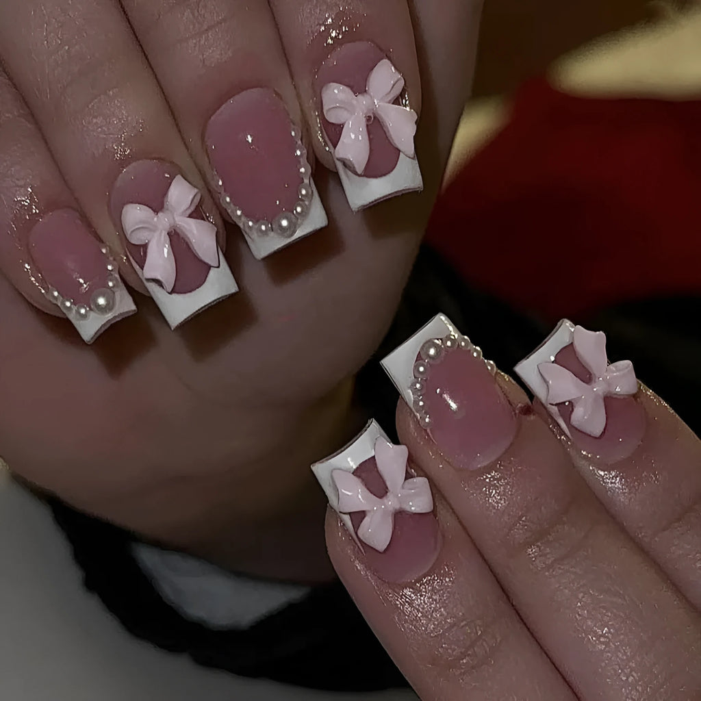 Set of 24 short French manicure false nails with white tips, bow designs, tulip patterns, and leopard print on a European square shape.