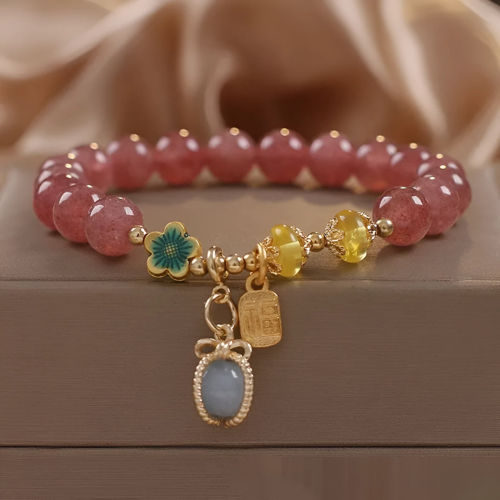 Red women's beaded bracelet with a strawberry quartz centre stone and sparkling rhinestones on an alloy chain.