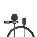 Close-up of a black wired lavalier lapel microphone with a 3.5mm plug clipped to a shirt collar.