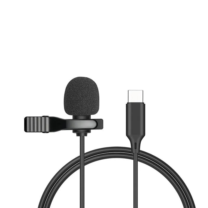 Close-up of a black wired lavalier lapel microphone with a 3.5mm plug clipped to a shirt collar.