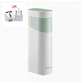 Small black instant water dispenser with digital display on a desktop.