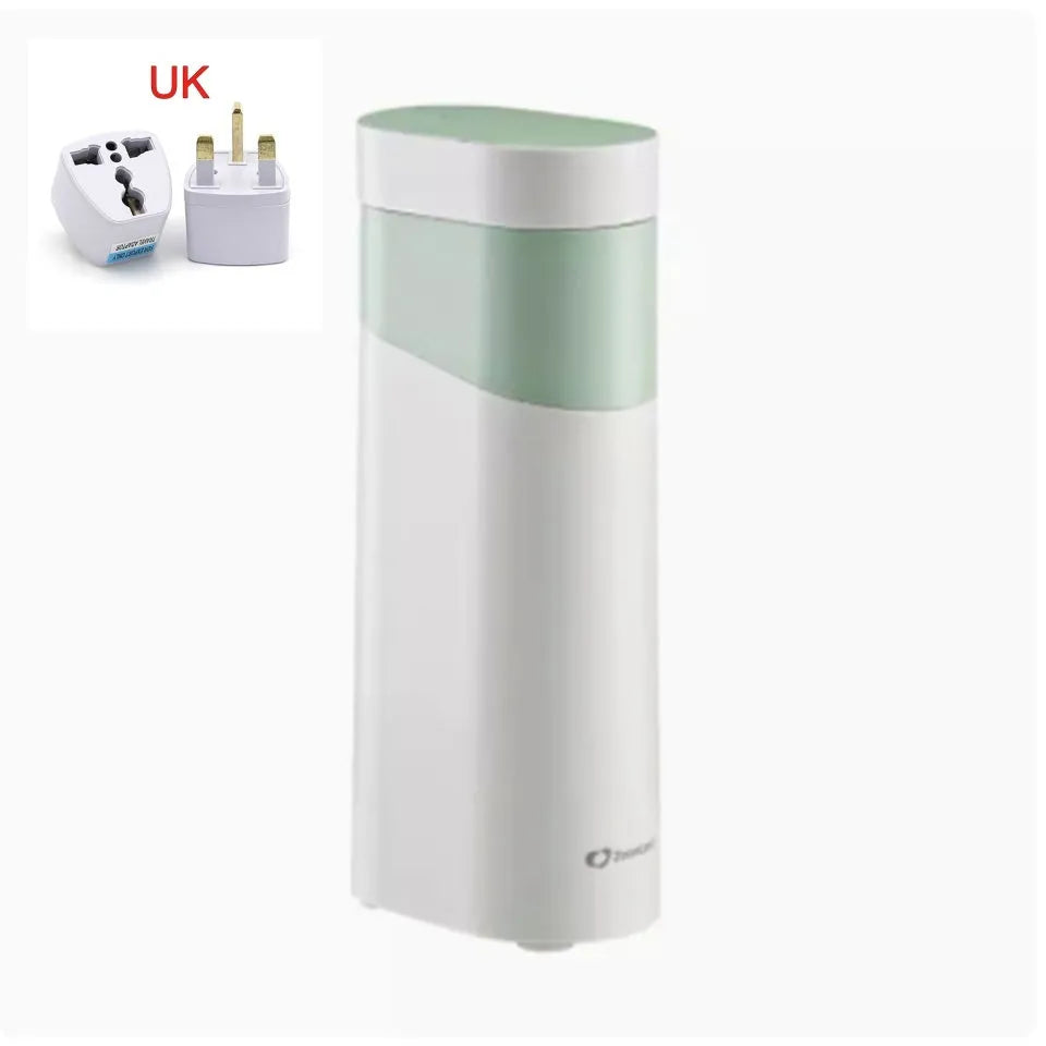Small black instant water dispenser with digital display on a desktop.
