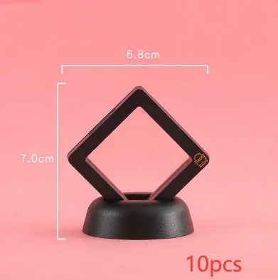 3D floating display case holding a coin suspended between transparent membrane sheets, black frame