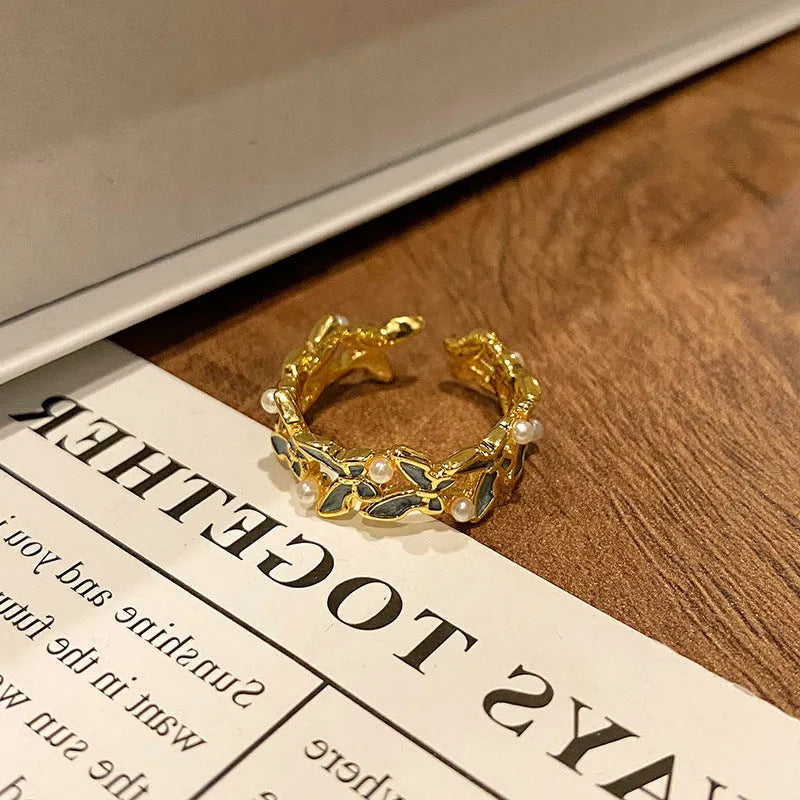 Simple copper women's ring with a Chinese butterfly design, showing an example from the 33 available numbered styles.