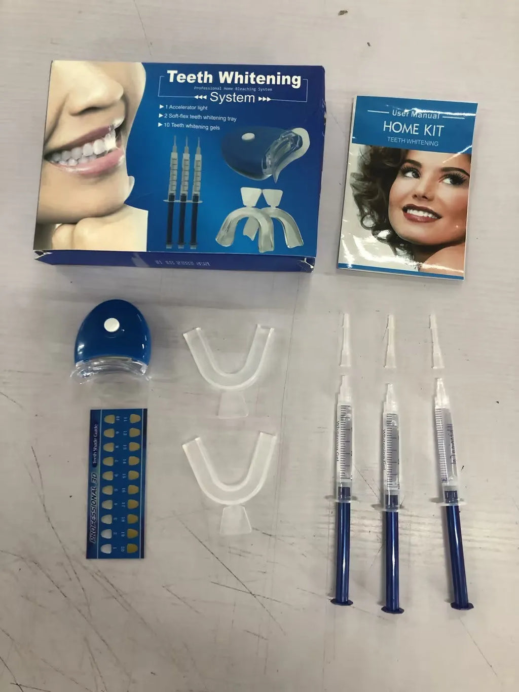 Teeth whitening kit with LED light and three 3ml gel sticks in blue packaging