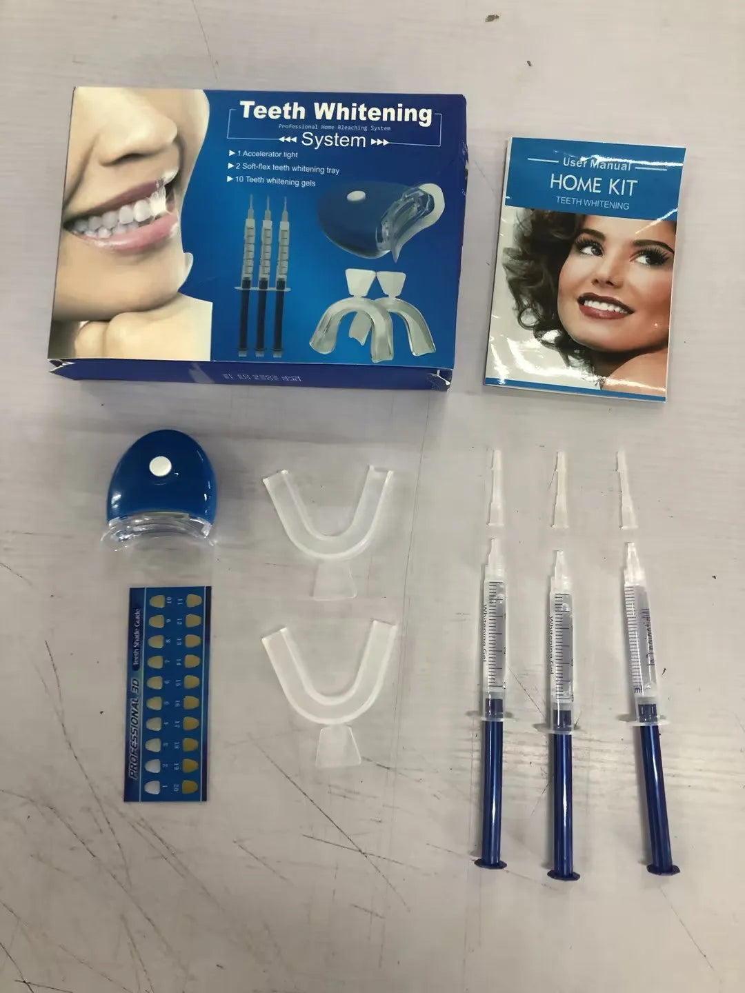 Teeth whitening kit with LED light and three 3ml gel sticks in blue packaging