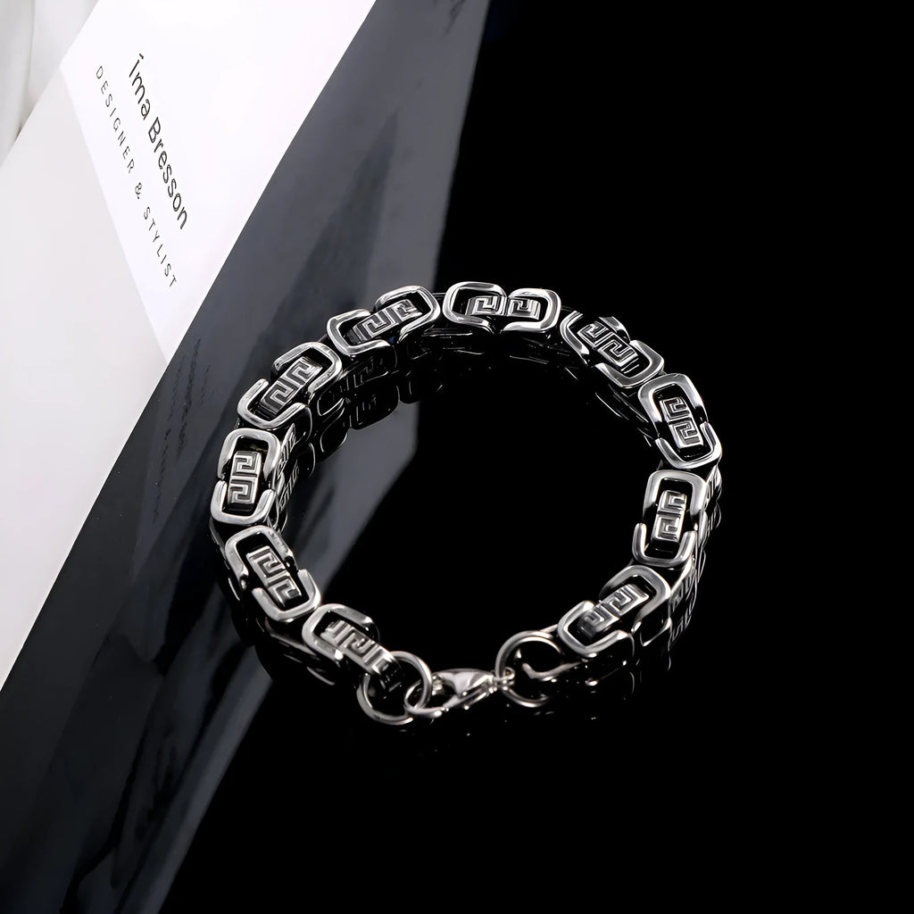 Retro black polished stainless steel geometric chain bracelet on a neutral surface