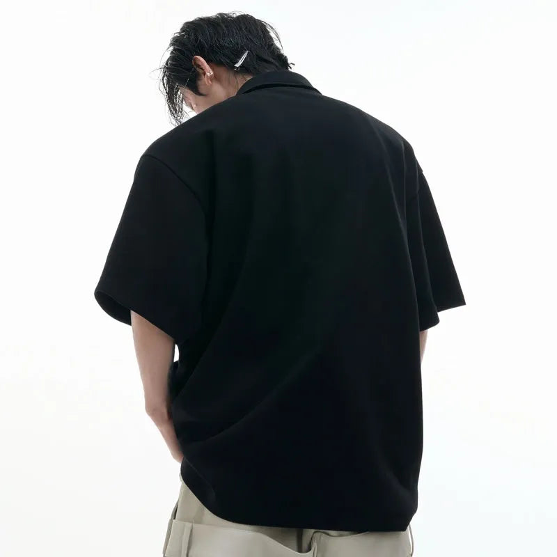 Men's loose fit polo shirt with deconstructed shirt collar and geometric pattern in grey.