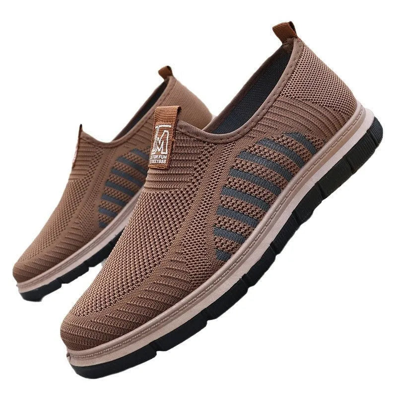 Men's slip-on casual sneakers with black mesh upper, low top, flat heel, and round toe.