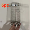 Round stainless steel rolling barbecue grilling basket with mesh sides and a hook, shown with assorted vegetables inside.