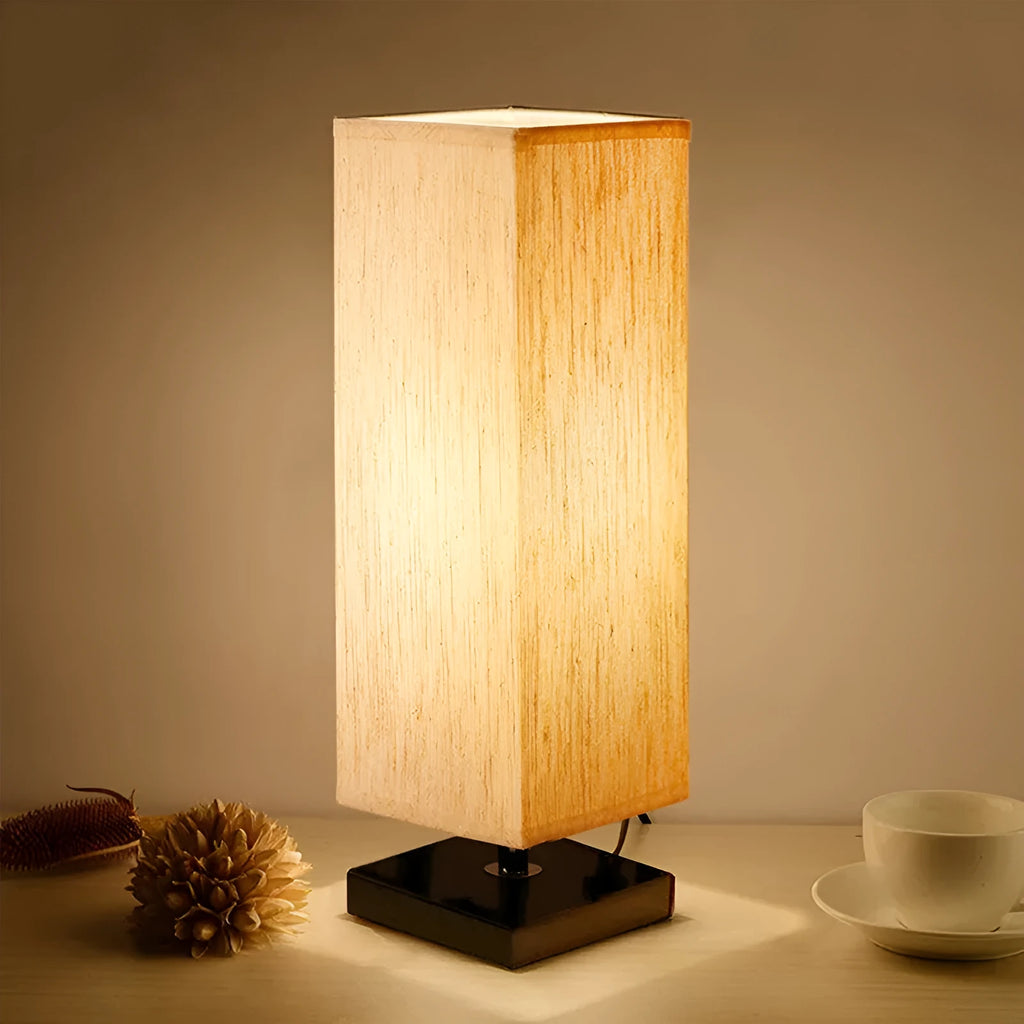 Modern square cloth covered table lamp with E26 socket on a wooden desk