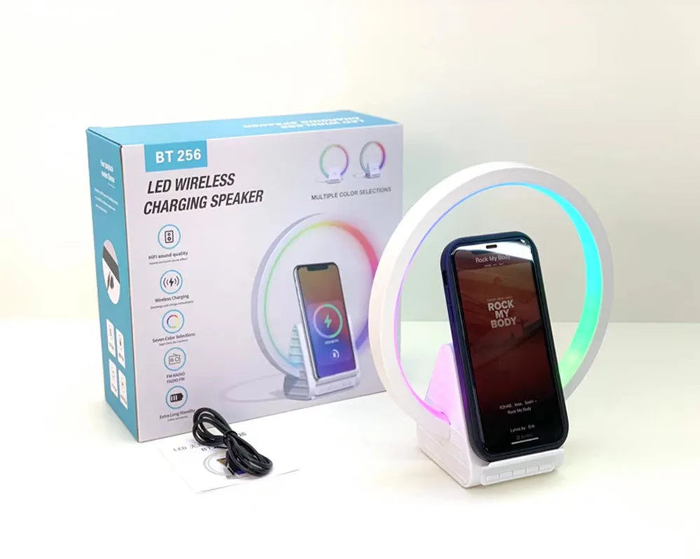 White smart Bluetooth speaker with wireless charging pad and ambient light ring