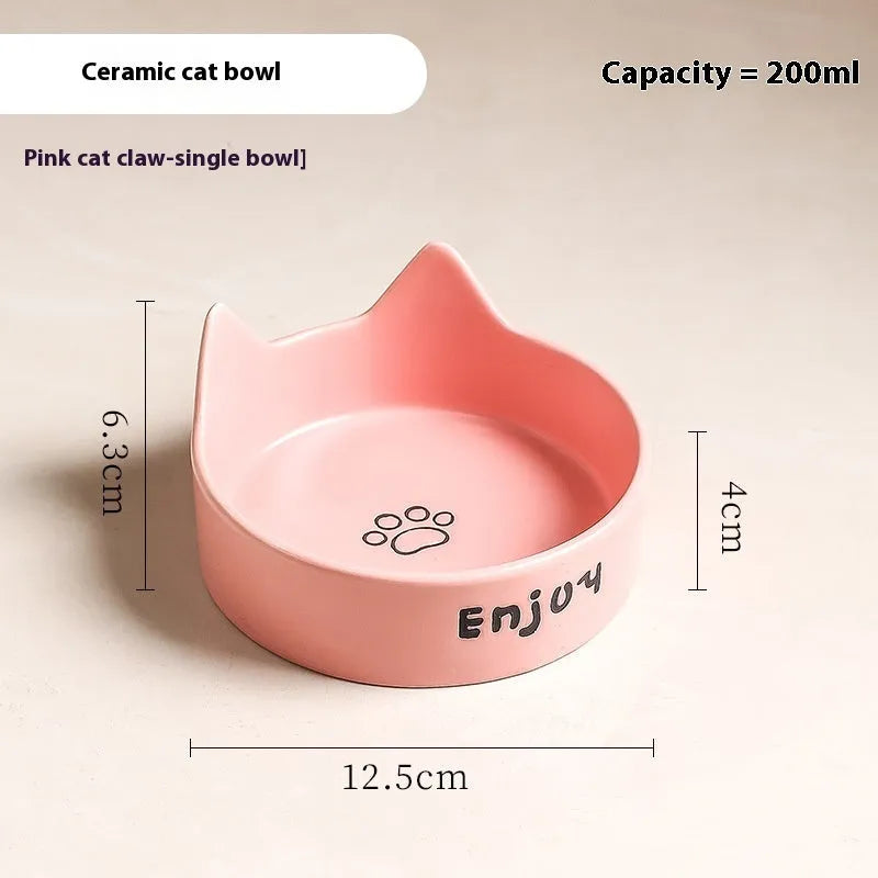 Porcelain cat bowl with cat ear and paw design on a wooden feeding frame, in pink colour.