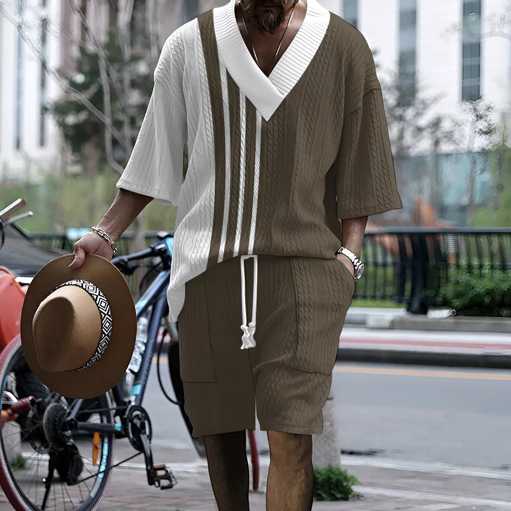 Man wearing a printed drop-shoulder knitted top and matching shorts from a leisure suit set.