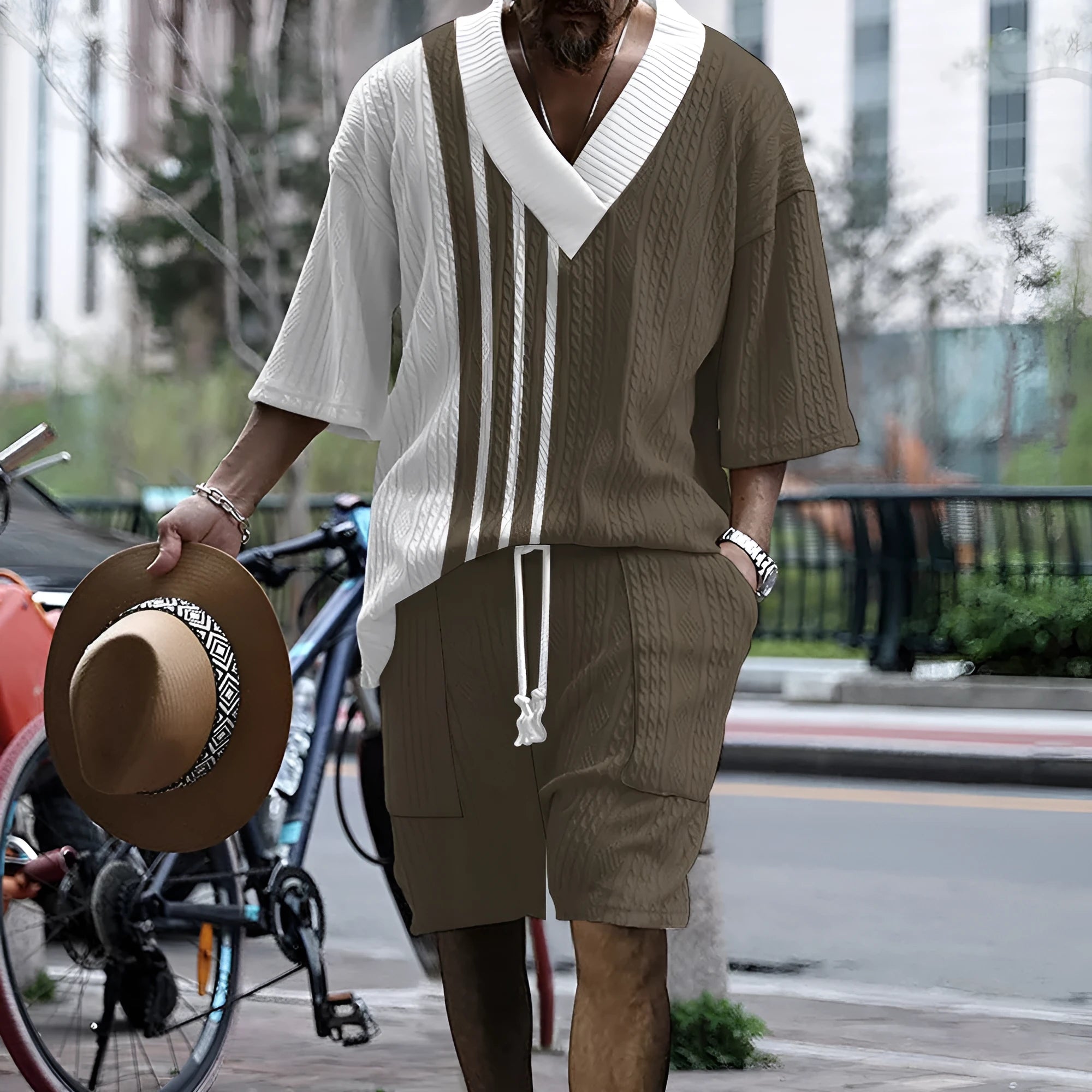 Man wearing a printed drop-shoulder knitted top and matching shorts from a leisure suit set.