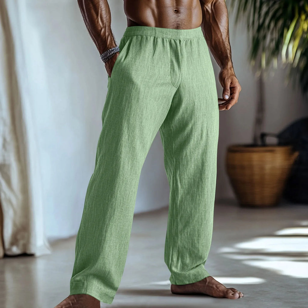 Straight-leg cotton linen trousers in light green on a hanger