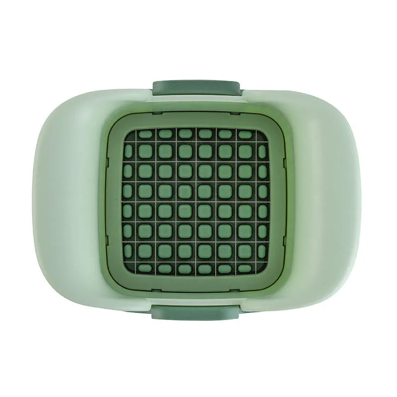 Green manual vegetable chopper with stainless steel blades for onions and potatoes.