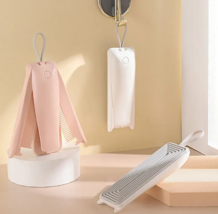 Pink and white plastic pet grooming brush for cats and dogs to remove floating hair