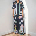Black women's casual set with cartoon print, featuring a cardigan and matching trousers