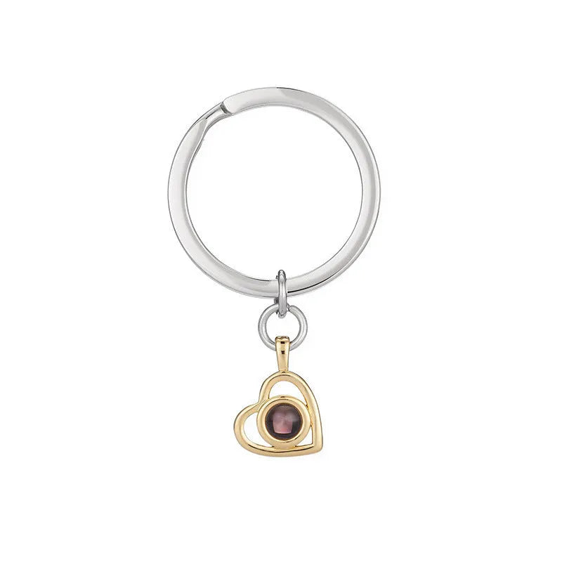 100 Languages I Love You necklace with heart-shaped charm showing custom photo projection inside, in gold finish