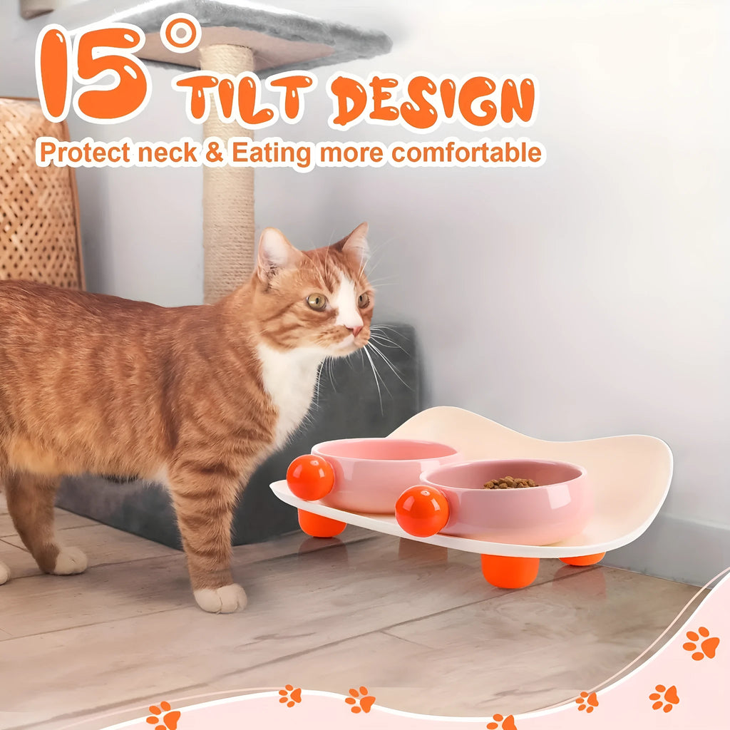 Pink elevated ceramic double bowl set for cat food and water on a non-slip base.