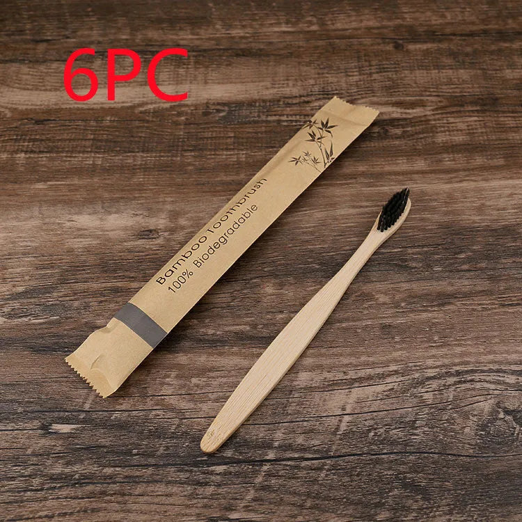 10 multi-coloured natural bamboo toothbrushes with soft charcoal bristles arranged on a white background