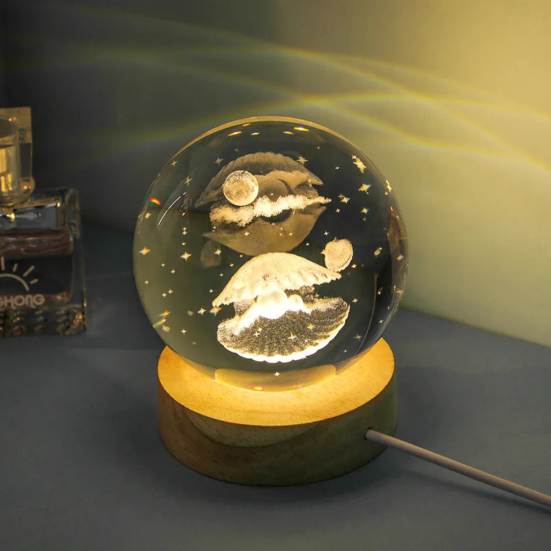 Transparent crystal ball night lamp with 3D carved jellyfish design, on a round base with USB cable.