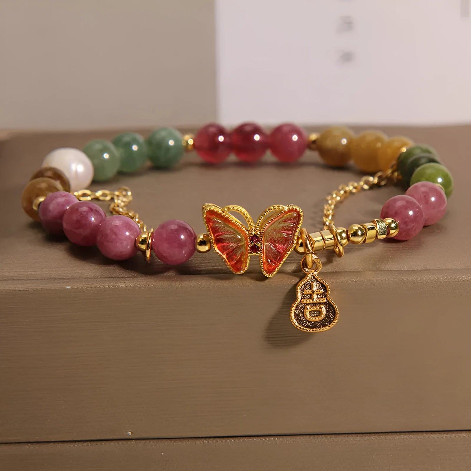 Natural jade coloured agate bracelet with butterfly and gourd pendant.
