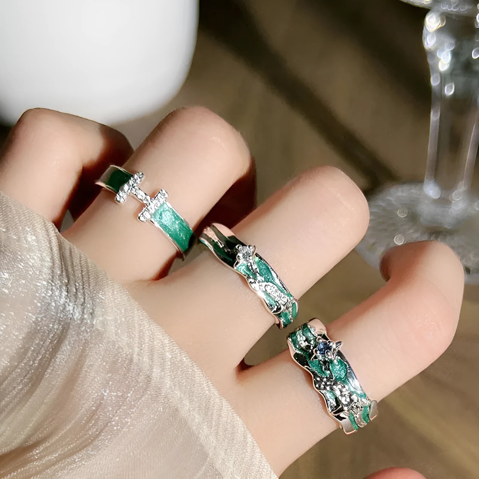 Mint green enamel asterism ring with custom text on copper, showing folding and asymmetric details.