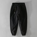 Men's army green cotton overalls with drawstring waist and ankle banded cuffs laid flat