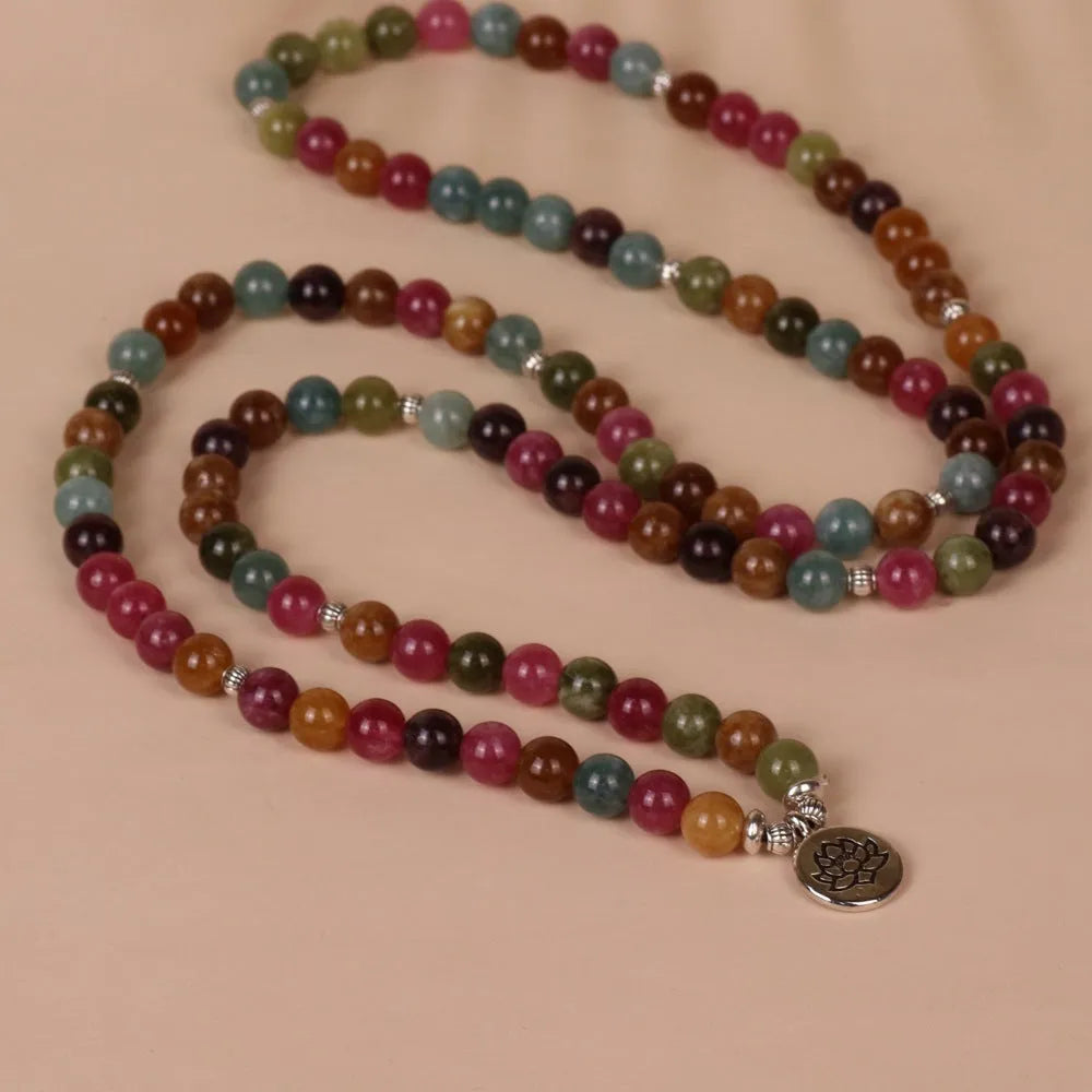 Multi-layer bracelet with 108 dark green tourmaline beads on a silver-toned alloy chain in a lotus design.