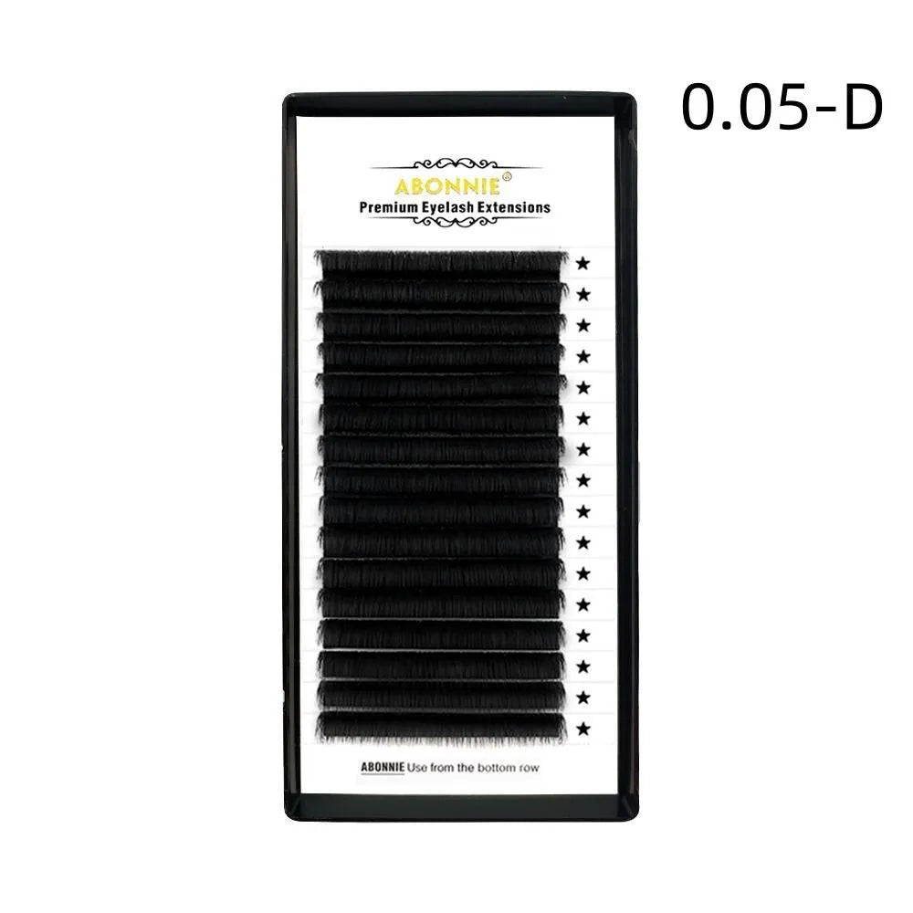 Pair of 16-row dense false eyelashes made from mink hair, showing matte round wool texture on a clear band.