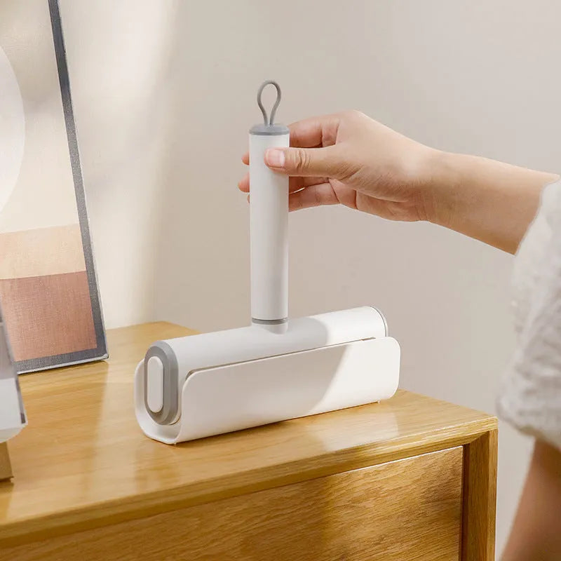 Floor lint remover roller tool for pet hair and dust removal with refillable adhesive roller core.