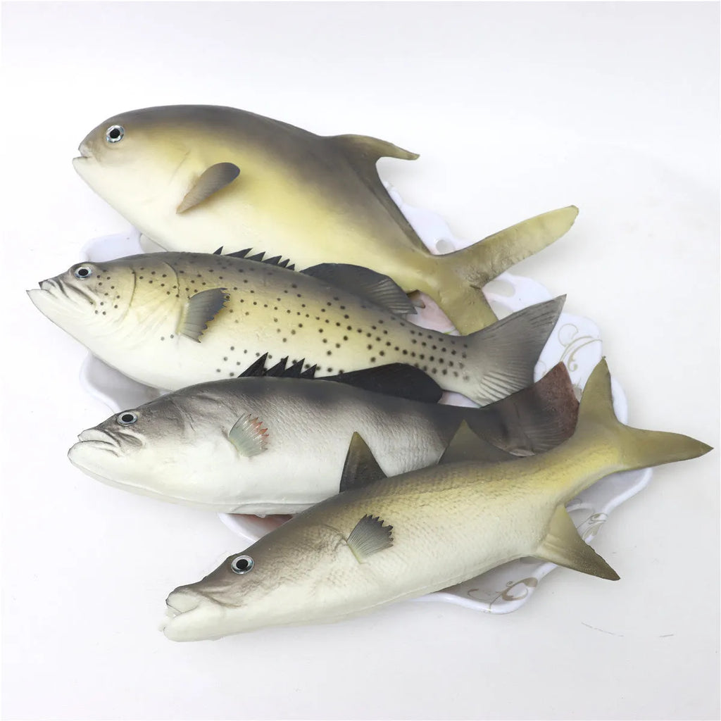 Detailed PU simulated fish ornament in yellow-fin tuna colour on a plain background.