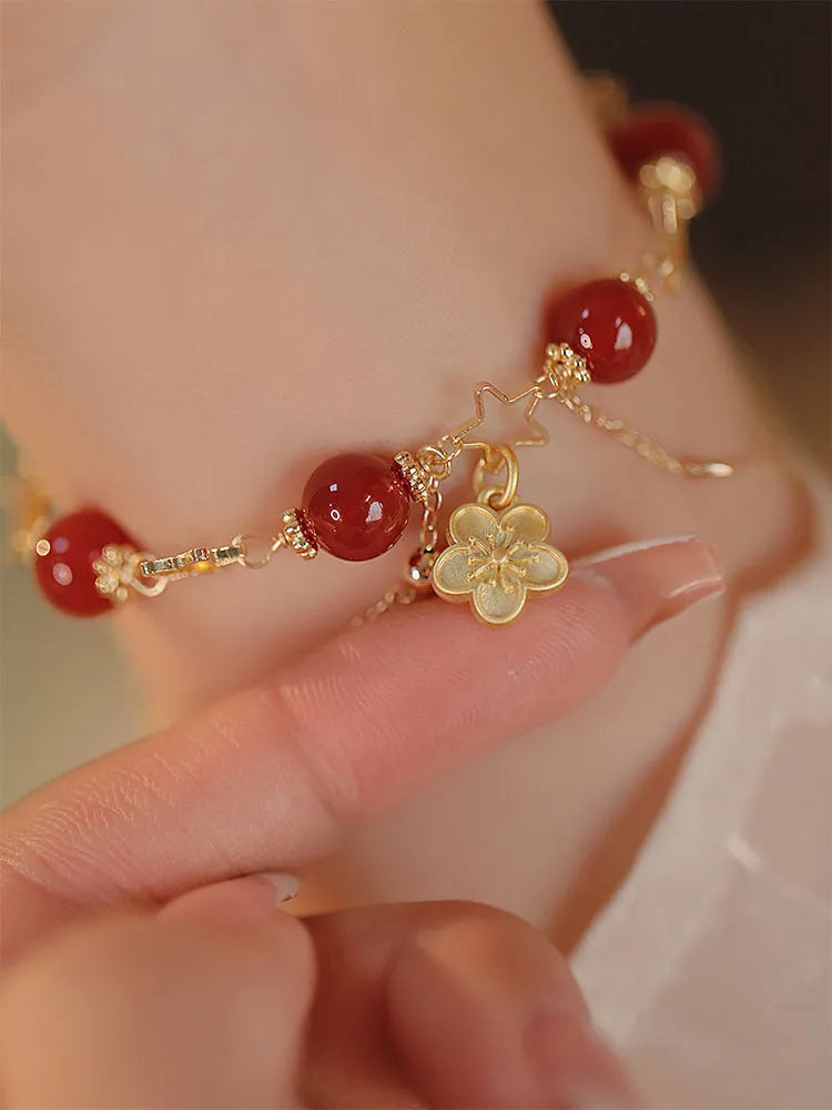 Women's red agate bracelet with double layer design and floral charms