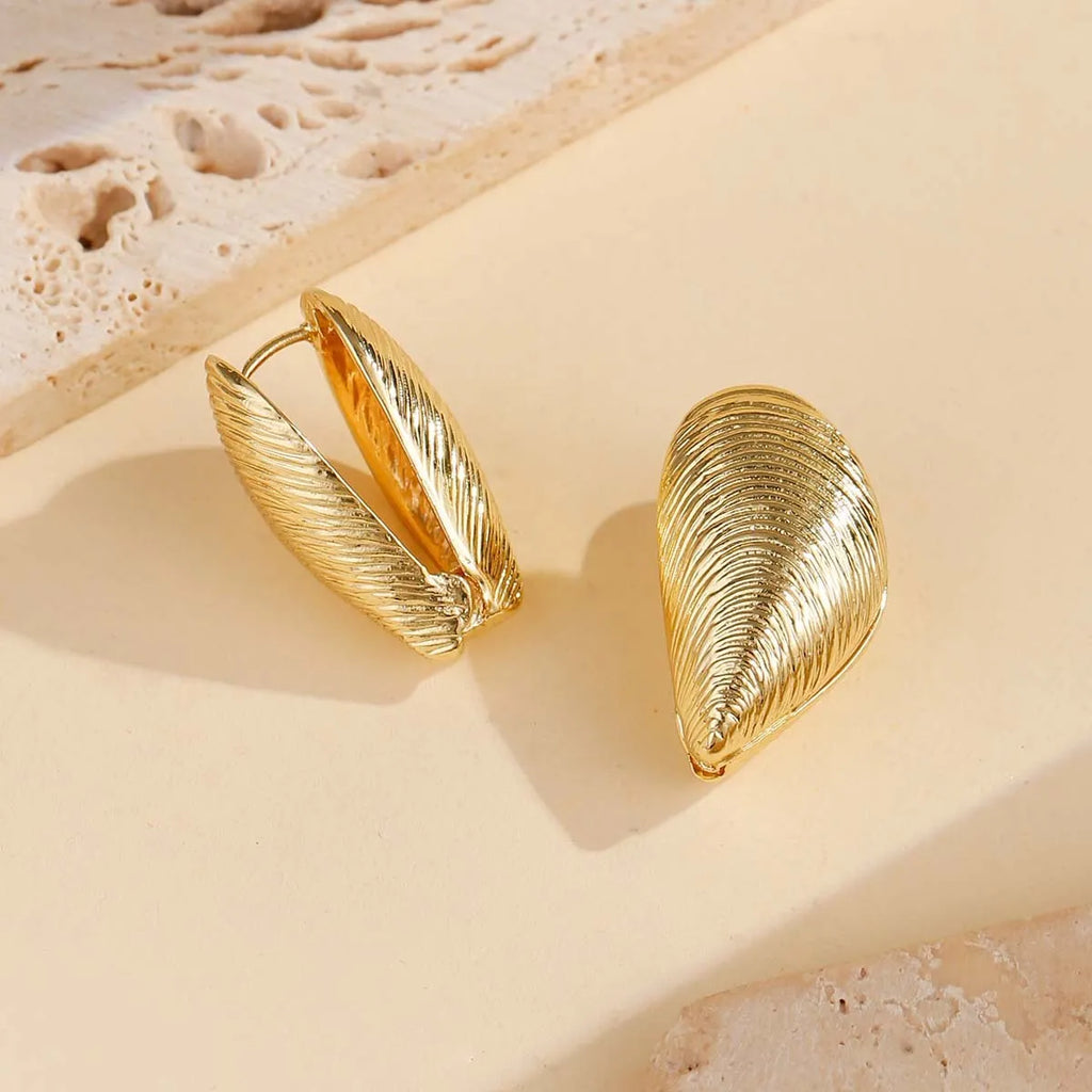 Gold geometric shell thread clip-on earrings on woman, beach ocean vacation style, zinc alloy electroplated ear clips
