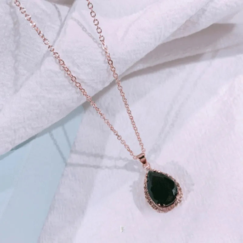 Women's water drop shaped pink necklace with rose gold rhinestone geometric detailing on alloy chain