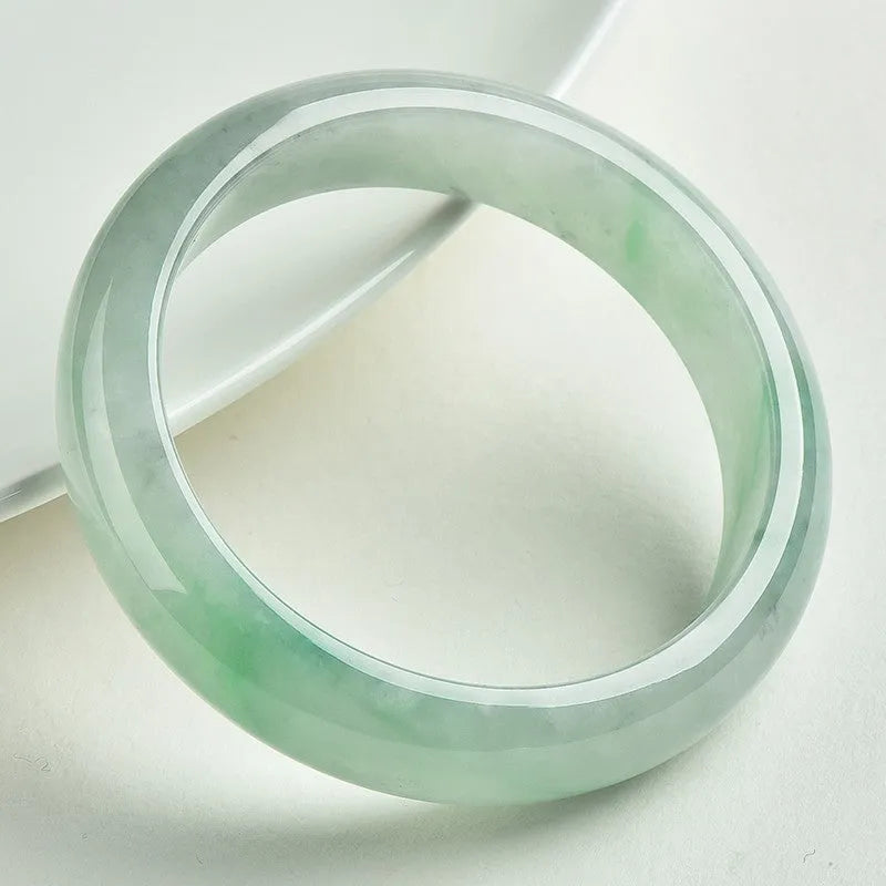 Light green jade bracelet showing natural stone material on wrist